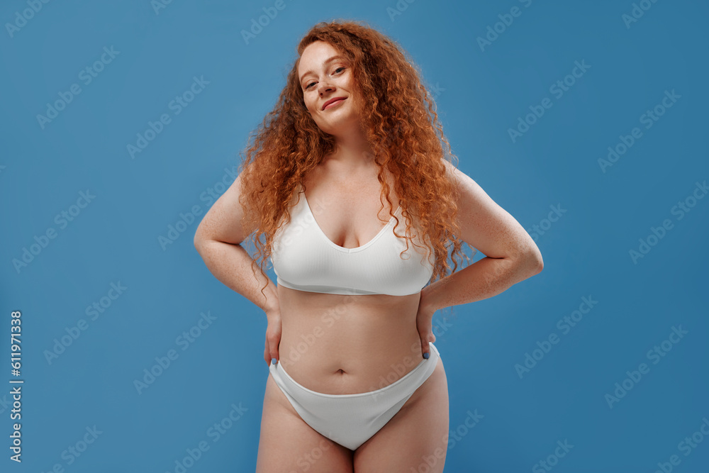 Redhead girl with freckles on a blue background Redhead girl with freckles on a blue background