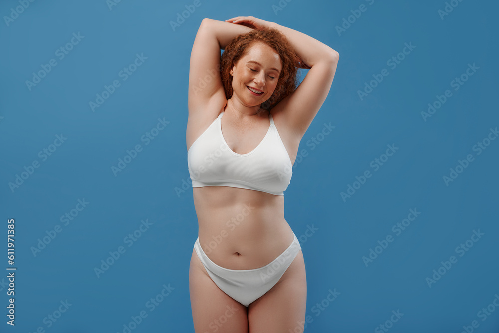 Redhead girl with freckles on a blue background Redhead girl with freckles on a blue background