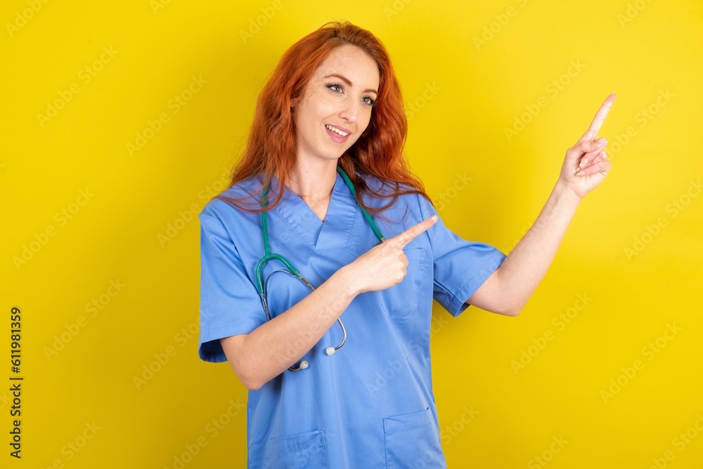 young red-haired doctor woman over yellow studio background smile excited directing fingers look empty space young red-haired doctor woman over yellow studio background smile excited directing fingers look empty space