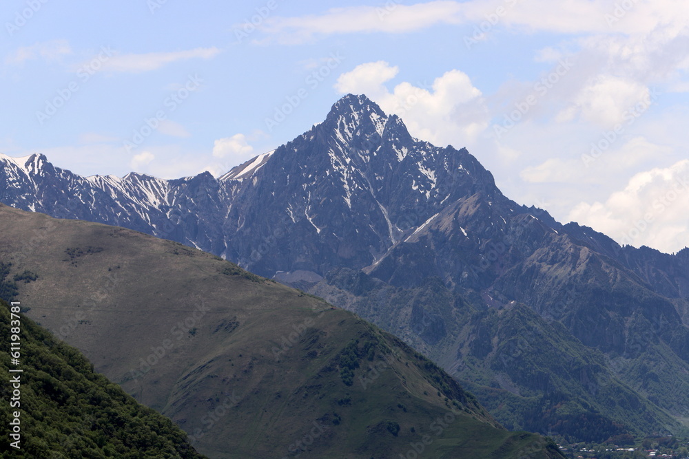 Snow-covered mountain peaks of the Main Caucasian Range. Landscape in the mountains of Georgia.