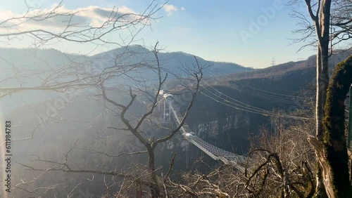 suspension swing bridge in the mountains across the abyss