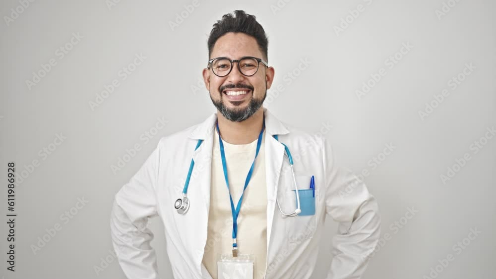 Young latin man doctor smiling confident standing over isolated white background Young latin man doctor smiling confident standing over isolated white background