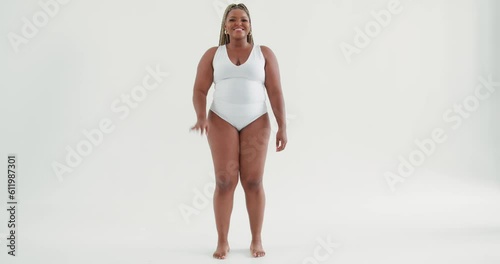 smiling happy plus size beautiful African woman waving hand saying hello hi posing in white sexy bodysuit lingerie, gesture body language Slow motion, sexy hot fat model dancer greeting photo