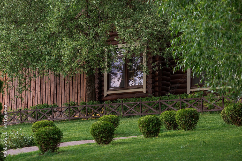 Beautiful landscape design in the park. Trimmed trees, smooth lawn. Plot design. The concept of outdoor recreation. Beautiful landscape design in the park. Trimmed trees, smooth lawn. Plot design. The concept of outdoor recreation.