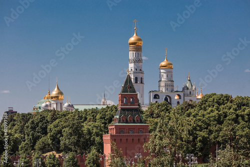 Moscow, Russia, June 2023: View of the bell of Ivan the Great in the Moscow Kremlin behind the Kremlin wall on a sunny summer day.