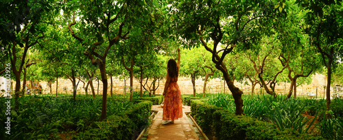 Tourist girl inside Alcazar de Los Reyes Cristianos gardens in Cordoba, Andalucia, Spain