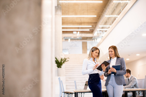 Two young business women lo...