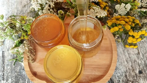 different various species of honey. fresh liquid honey with herbs at tray