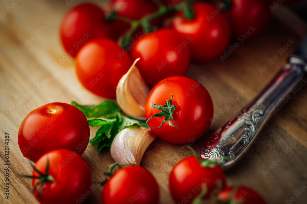 tomatoes with basil, garlic and a knife on a cutting board tomatoes with basil, garlic and a knife on a cutting board