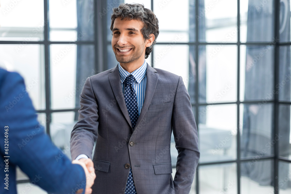Business people shaking hands, finishing up a meeting. Business people shaking hands, finishing up a meeting.
