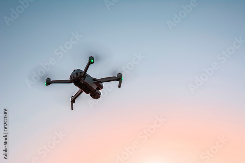 drone flying in the sky at sunset