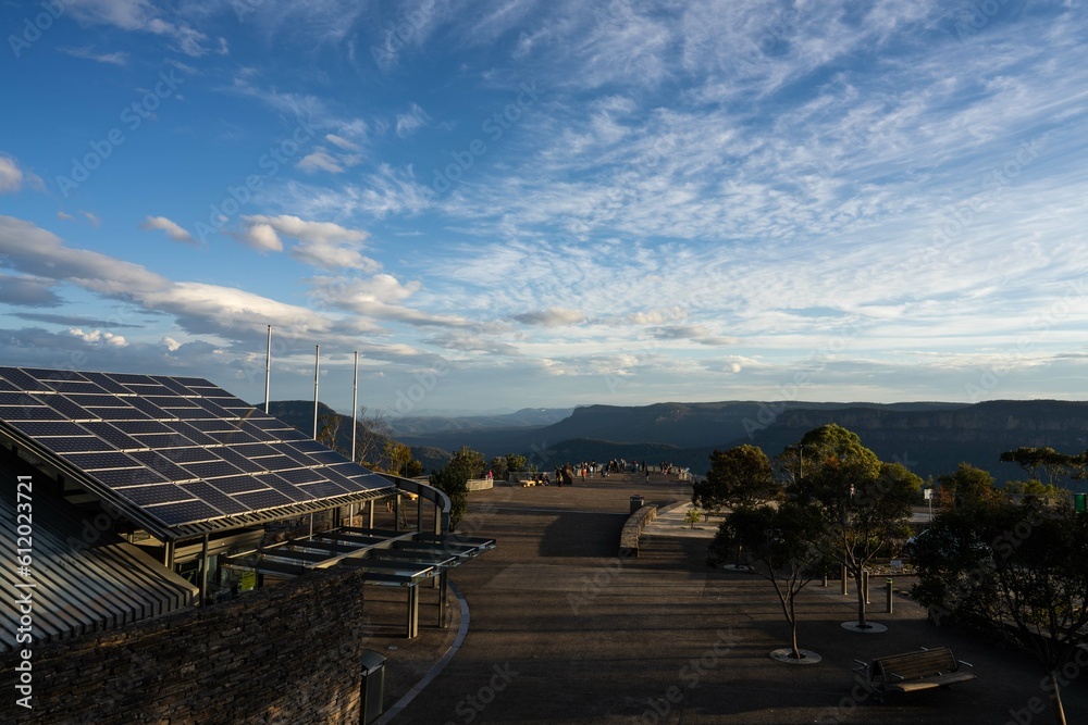 Solar panels on the roof of a government building with a view over a canyon