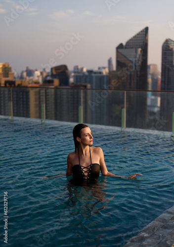 Beautiful girl in the pool in the water.