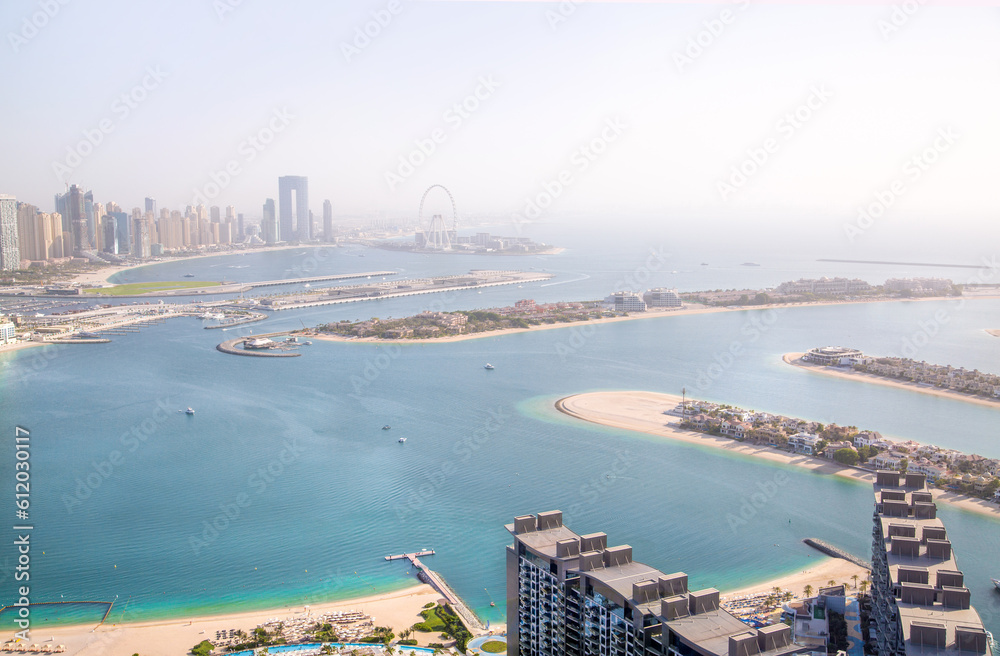Dubai, UAE - August 28, 2022:  Beaches and Dubai eye view at sunset with boats and yachts in the Persian gulf waters. Panoramic view at Dubai Marina