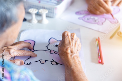 Elderly painting works of cartoon artwork as a hobby activity for exercise hand and brain.