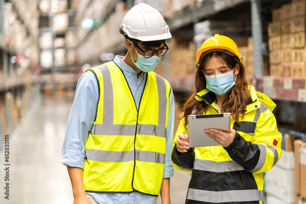 Asian two engineer team shipping order detail on tablet check goods and supplies on shelves with goods background inventory in factory warehouse.logistic industry and business export Asian two engineer team shipping order detail on tablet check goods and supplies on shelves with goods background inventory in factory warehouse.logistic industry and business export