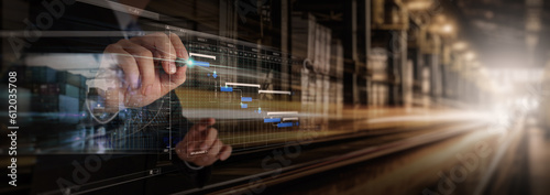 Businessman working virtual interface panel of global logistics network distribution and transportation, Smart logistics, Innovation future of transport on large warehouse center background