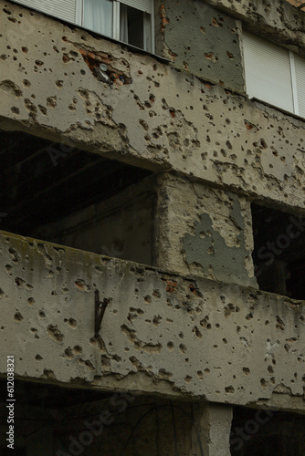 wall of a building with bullet holes