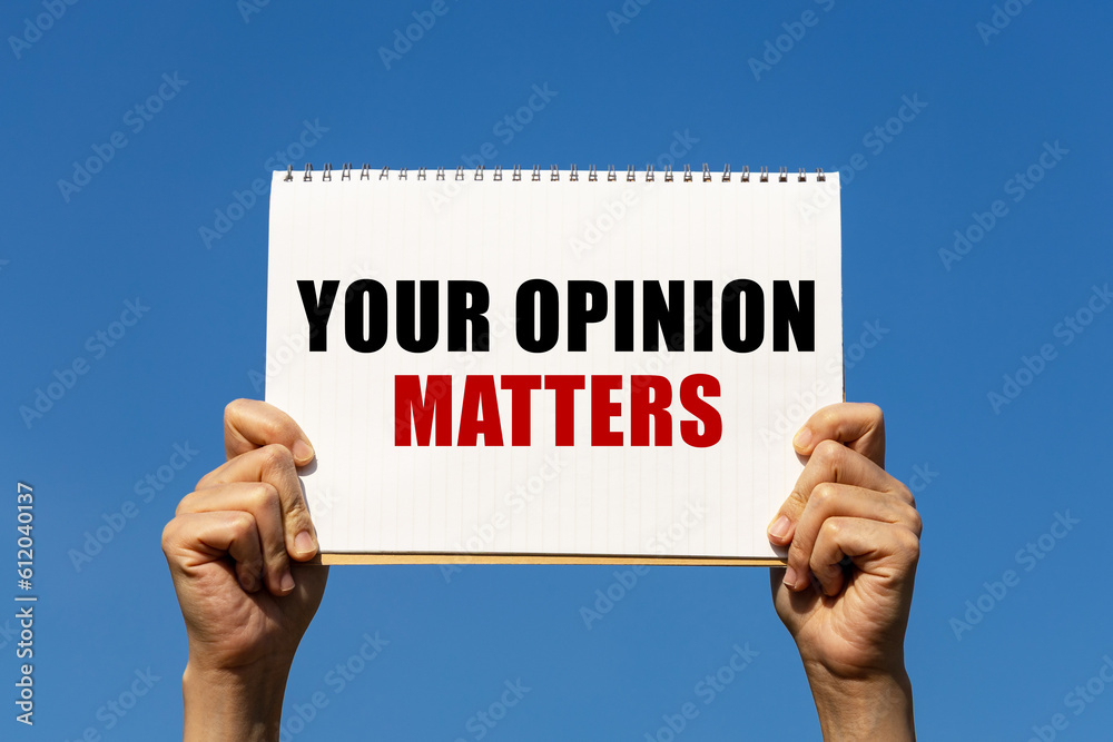 Your opinion matters text on notebook paper held by 2 hands with isolated blue sky background. This message can be used as business concept about opinion. Your opinion matters text on notebook paper held by 2 hands with isolated blue sky background. This message can be used as business concept about opinion.