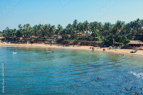 Fototapeta Naklejka Na Ścianę i Meble -  Sunny Beach with Tourists in the Goa state, India