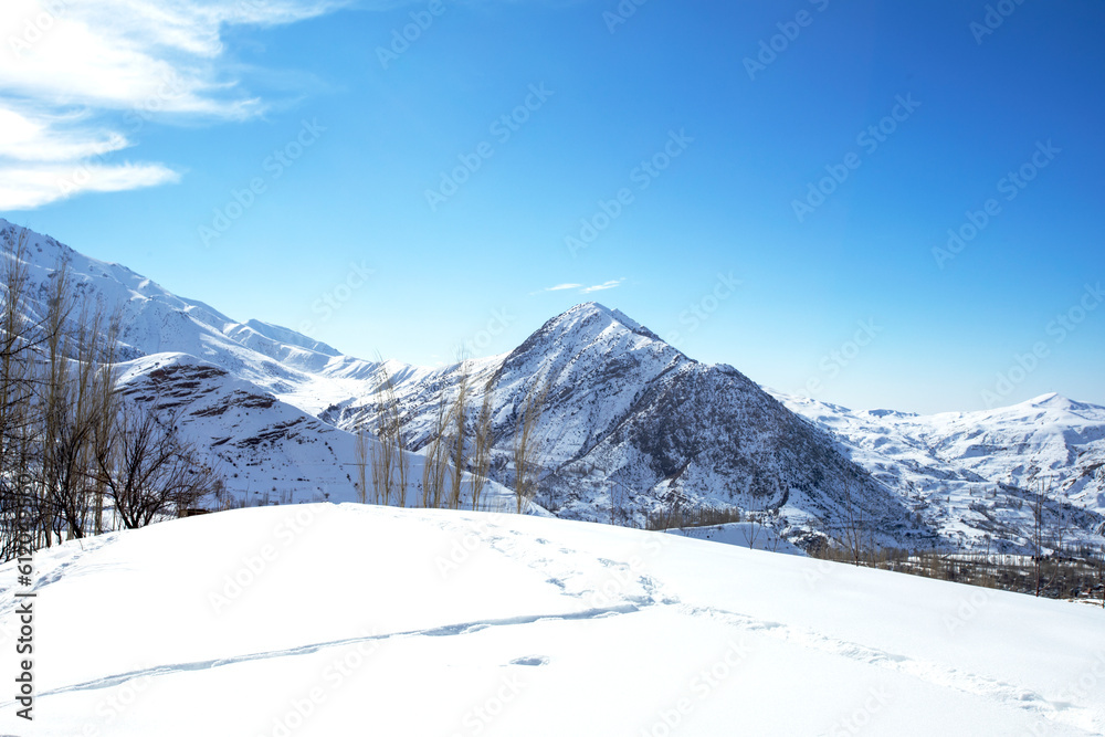 Snowy ridges against the blue sky