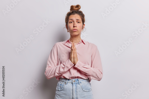 Принти на полотні Female presses her hands together in prayer with expression of longing she plead