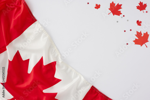 Happy Victoria Day concept. Top view flat lay of canadian flag, red maple leaves, confetti on white background with blank space for text or advert