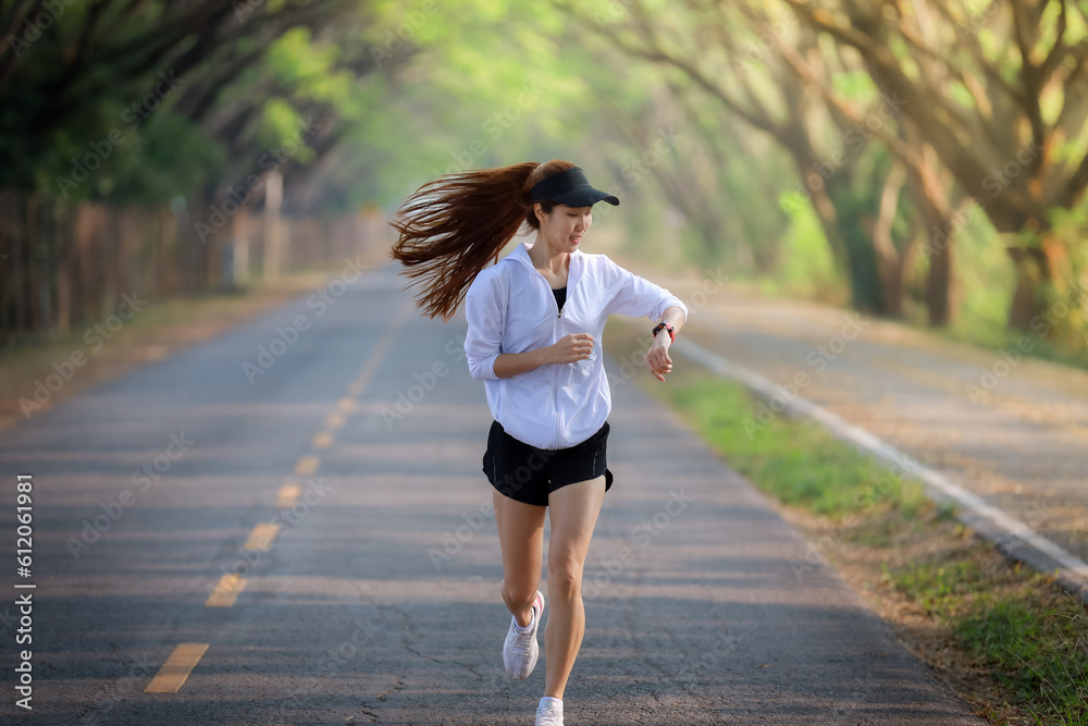 young woman relax in garden road evening ,woman fitness silhouette sunrise jogging workout wellness concept.
