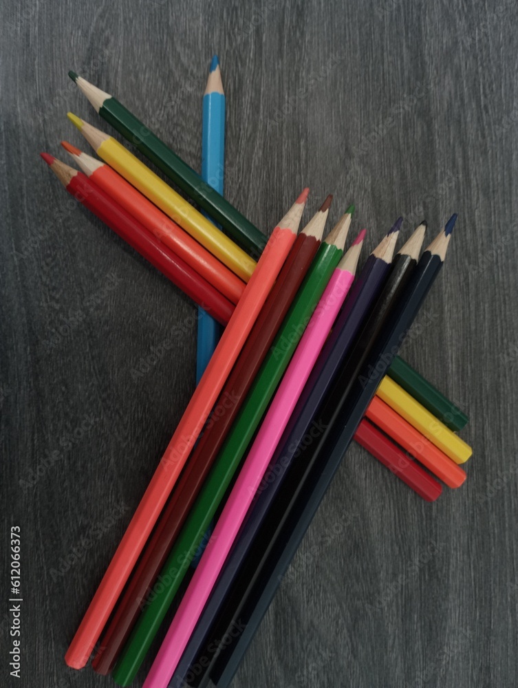Texture of pencils lying on top of each other on a gray background Texture of pencils lying on top of each other on a gray background
