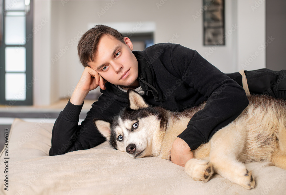 Guy with his Siberian Husky at home. Love animals.