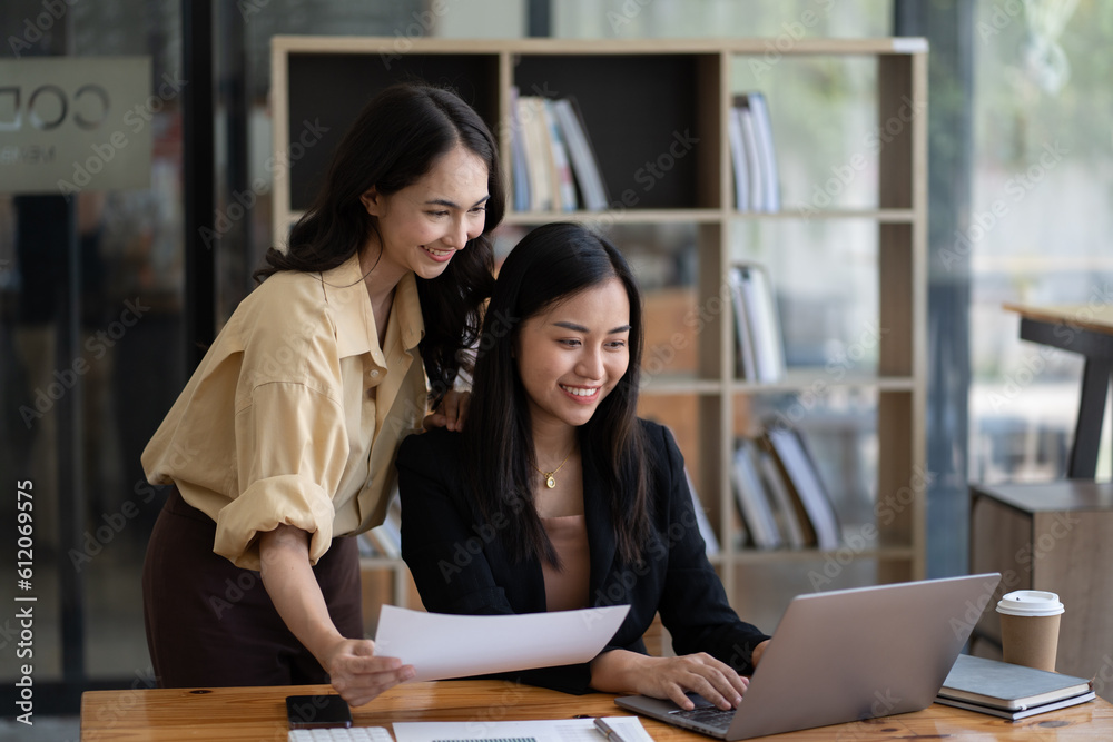 Two asian businesswoman sitting and consulting business inside modern office Two asian businesswoman sitting and consulting business inside modern office