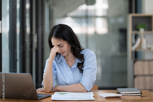 business woman frustrated and stressed holding by head.