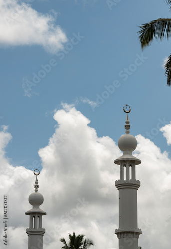 Beautiful mosque minaret image with cloudy blue sky on the background  Eid Mubarak background