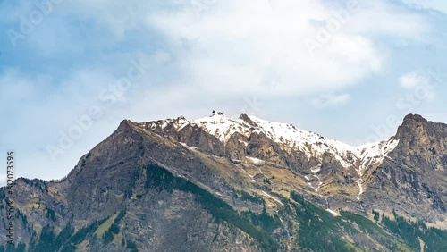 Timelapse video of clouds passing the jagged, snow-capped mountain tops around the Switzerland-Liechtenstein border.  Graubünden, Switzerland. photo