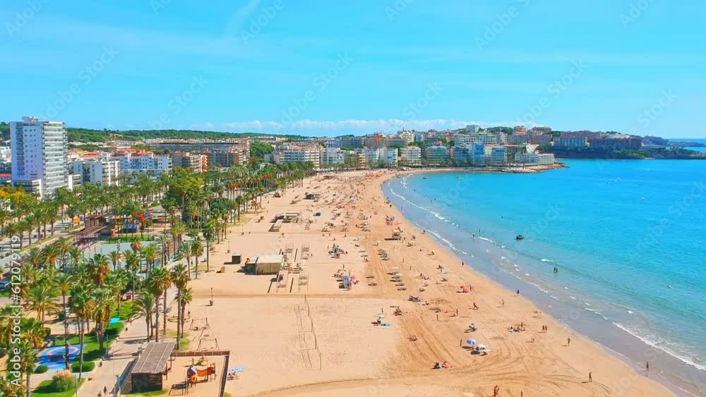 Beach in Catalan city Salou, Spain, Europe. Sea and palm in Catalonia