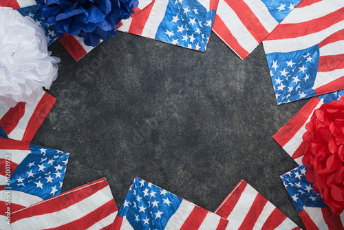 Fototapeta Naklejka Na Ścianę i Meble -  4th of July background. USA paper fans, Red, blue, white stars, balloons, gold confetti on gray dark concrete background. Happy Labor, Independence or Presidents Day. American flag colors. Top view.