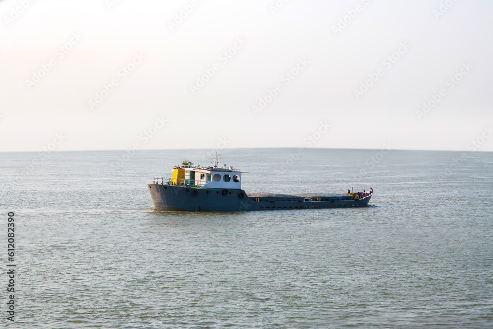 Empty Cargo ship container moving on the waters of the sea.