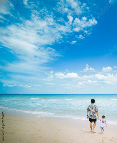 Happy fother and son resting at beach in summer,Thailand