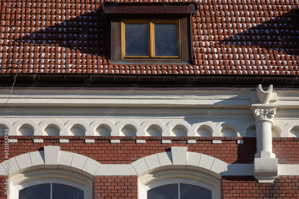 A small section of the roof and cornice of a historic neo-Gothic-style building.
