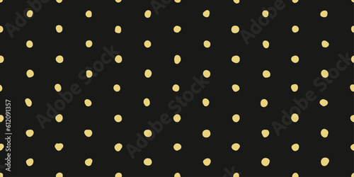 Simple casual stylish polka dots. Several curved yellow dots on a black background in a seamless pattern. Vector and stylish pattern for design and surfaces.