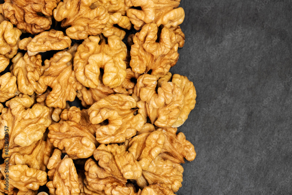 Walnuts. Walnut kernels on dark stone table. Top view Walnuts. Walnut kernels on dark stone table. Top view