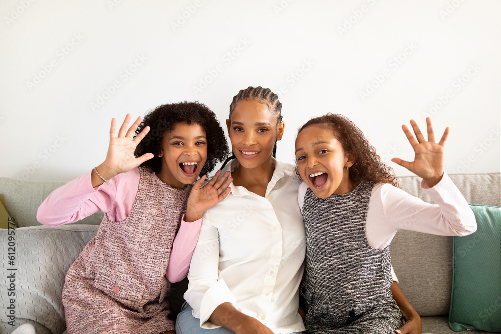 Funny African American Daughters And Mom Waving Hands At Home Funny African American Daughters And Mom Waving Hands At Home