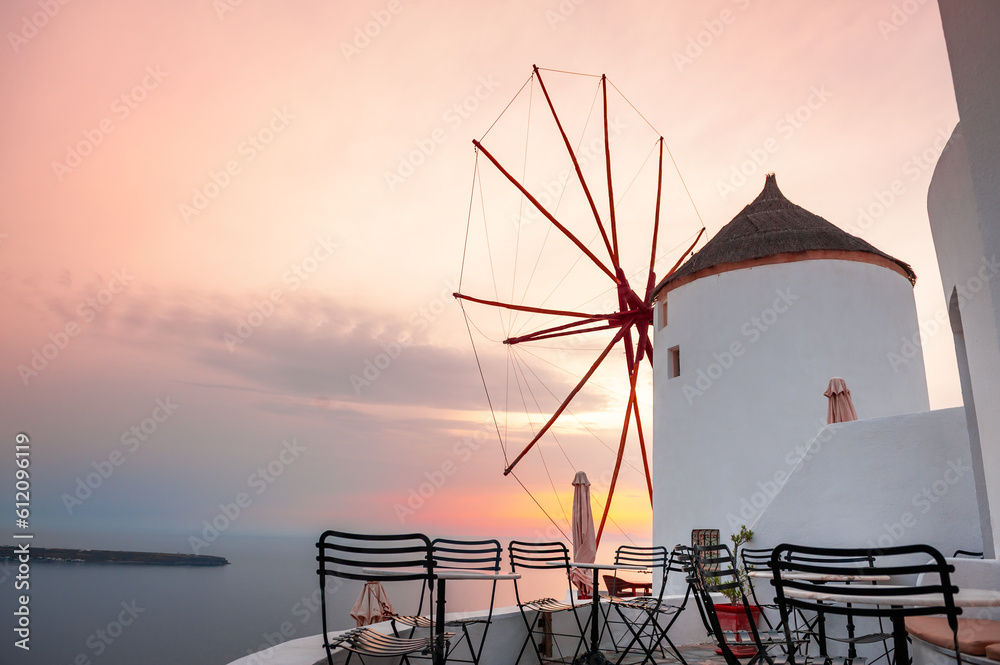 Famous windmill at sunset in Santorini island, Greece.