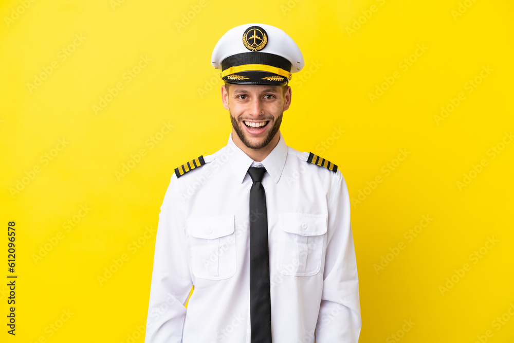 Airplane caucasian pilot isolated on yellow background with surprise facial expression Airplane caucasian pilot isolated on yellow background with surprise facial expression