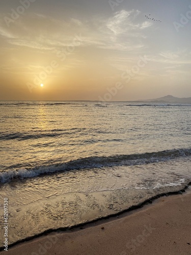 Golden hour in the reflection of the waves and the shores of the Red Sea