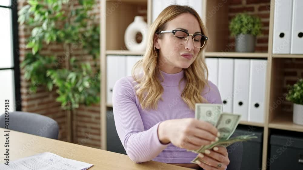 Young beautiful hispanic woman business woman holding dollars at office Young beautiful hispanic woman business woman holding dollars at office