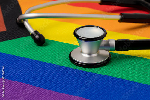 Rainbow pride flag and stethoscope. Transgender and LGBTQ+ healthcare and mental health concept. photo