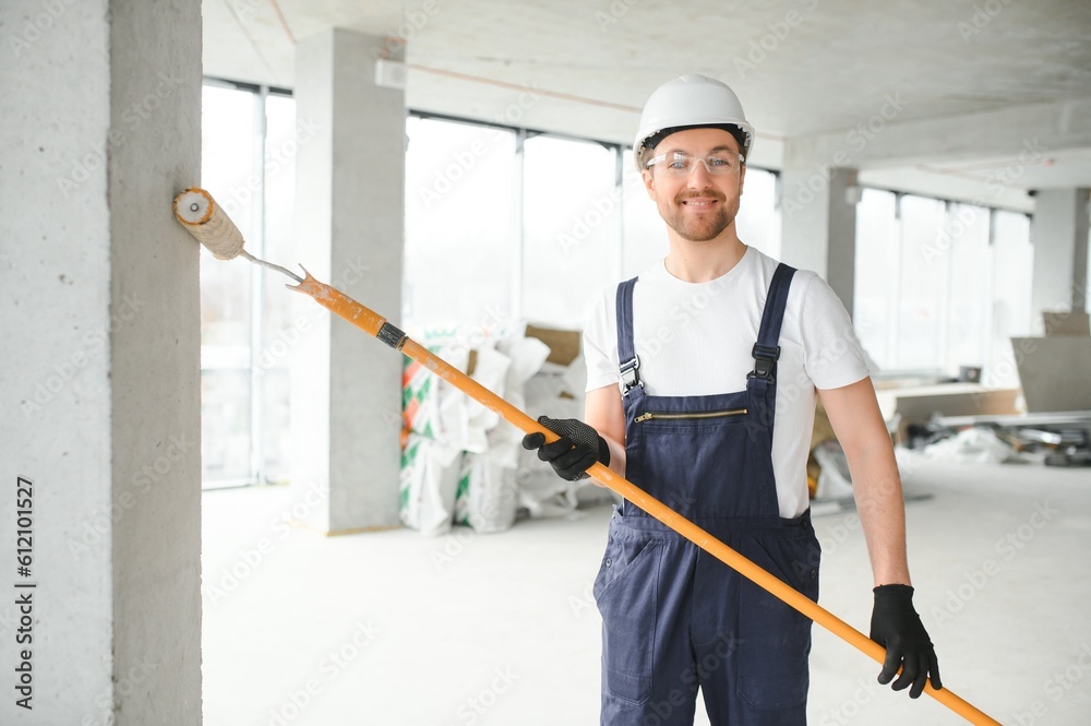 Worker renewing apartment on wall background. Worker renewing apartment on wall background.