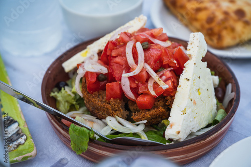 Cretan salad in Greece with tomato, onions and feta cheese in bread loaf