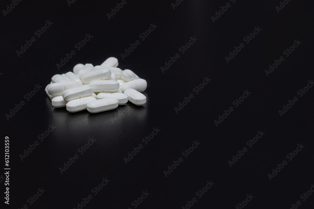 Pills, medicines, painkillers on the black table Pills, medicines, painkillers on the black table